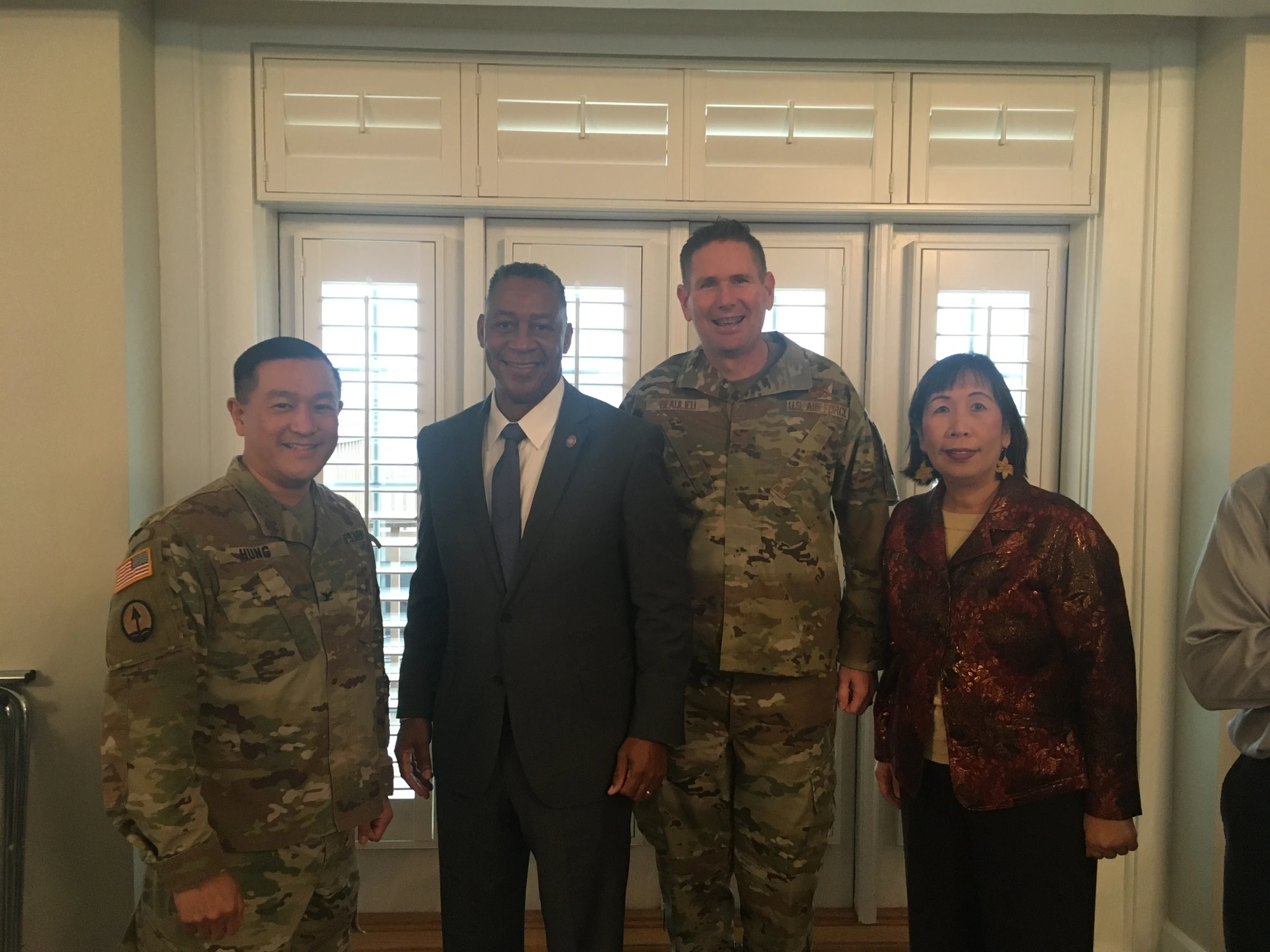 Four people posing - two military personnel and two civilians