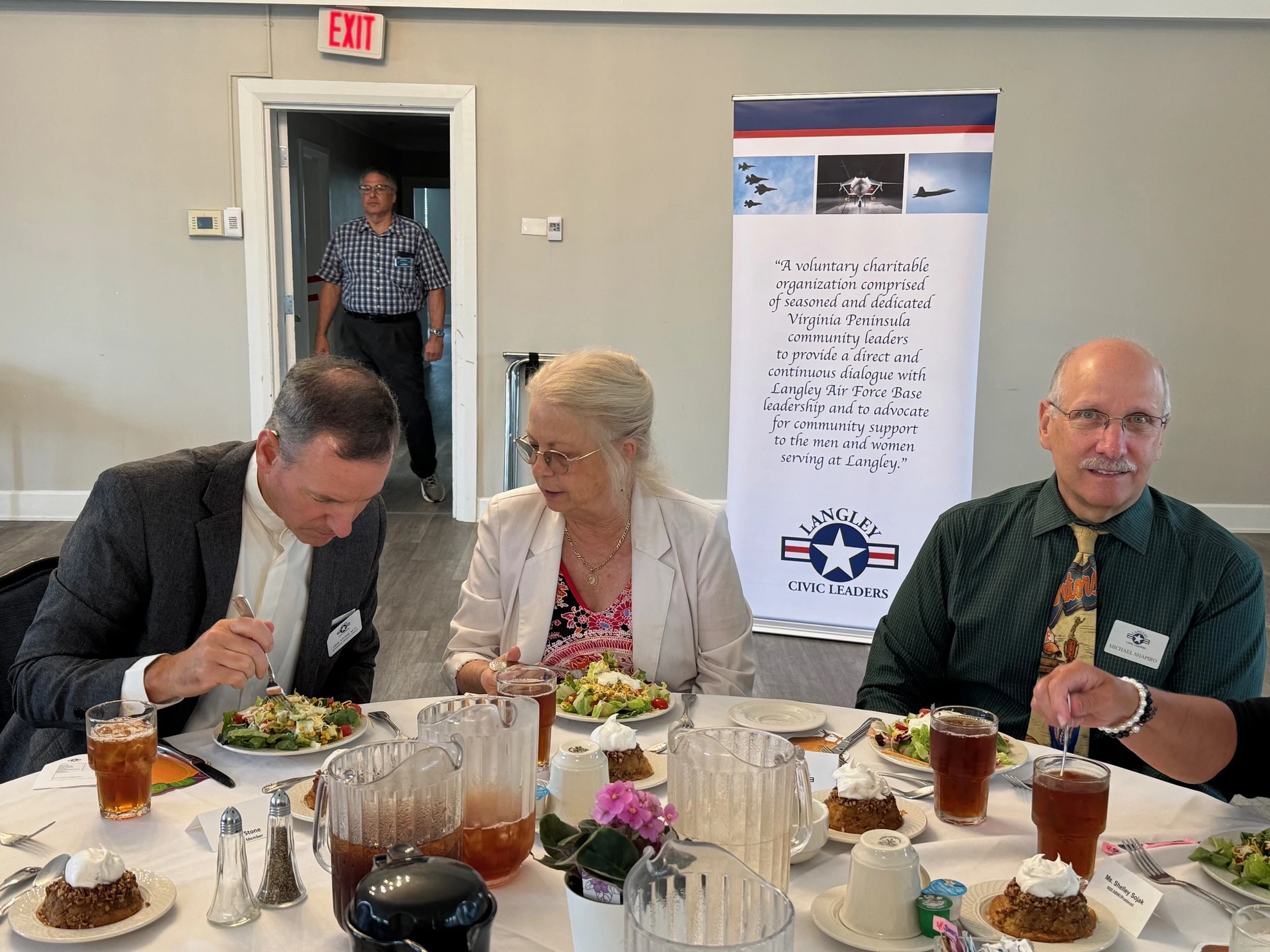 LCLA members dining with mission banner visible