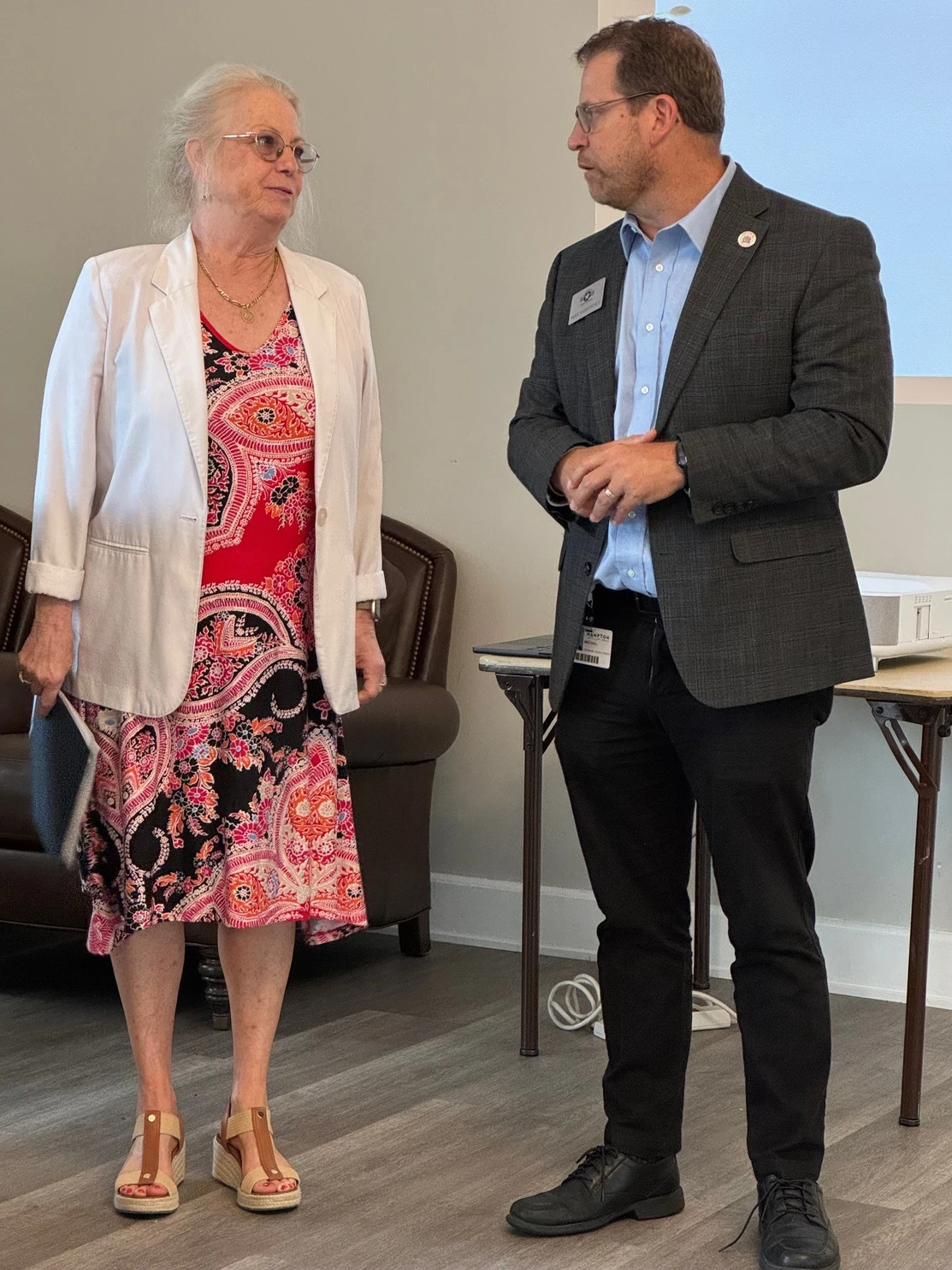 Two members in conversation before the luncheon